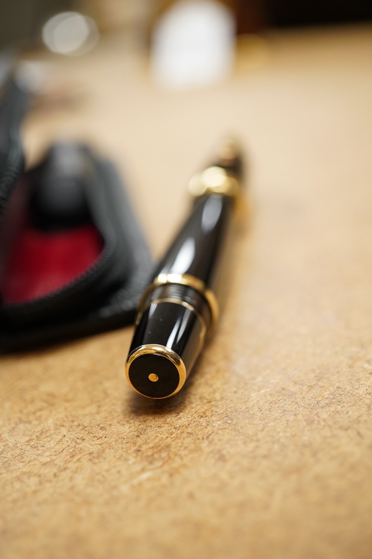 A leather cased Mont Blanc pen with retractable nib and decorative jewelled clip, 11cm long